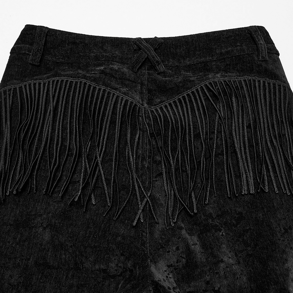 Close-up of Wasteland black flare pants showcasing unique tassel detailing and plush velvet fabric texture.