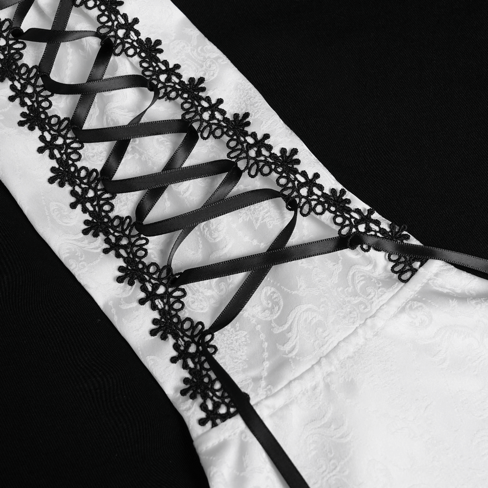 Close-up of black lace and corset ties on a white Victorian blouse, showcasing gothic elegance and intricate details.