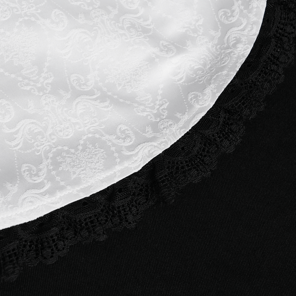 Close-up of black blouse neckline featuring elegant white lace trim and rich damask pattern.