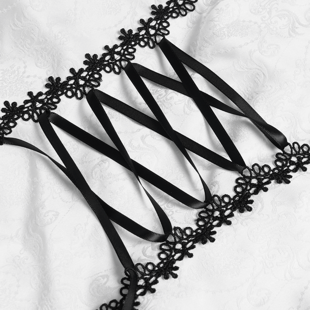 Black lace trim and corset lacing detail on a white Gothic Victorian blouse for a dramatic steampunk look.