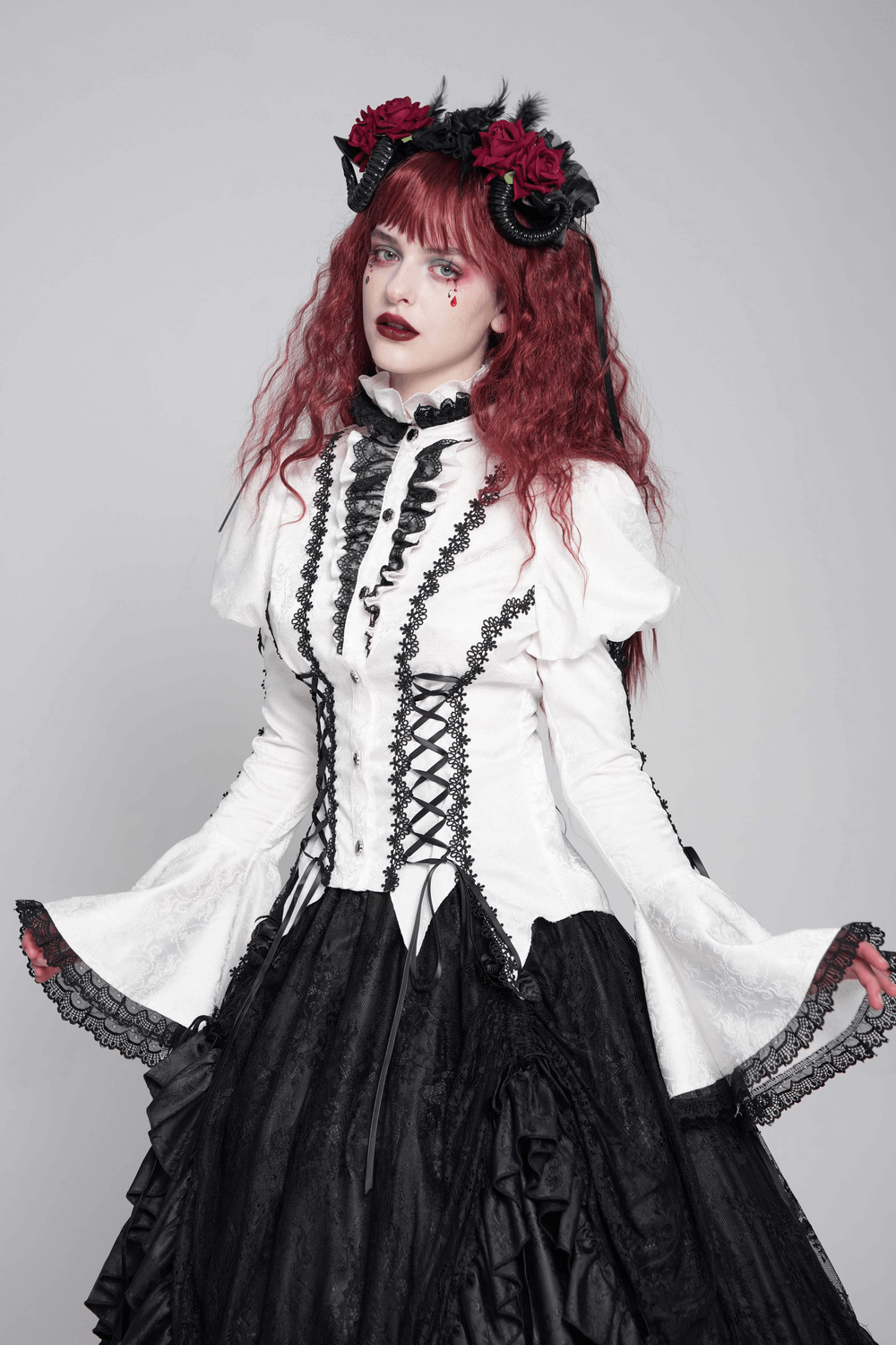 Victorian-inspired white blouse with corset ties and flared sleeves, perfect for gothic and steampunk fashion.