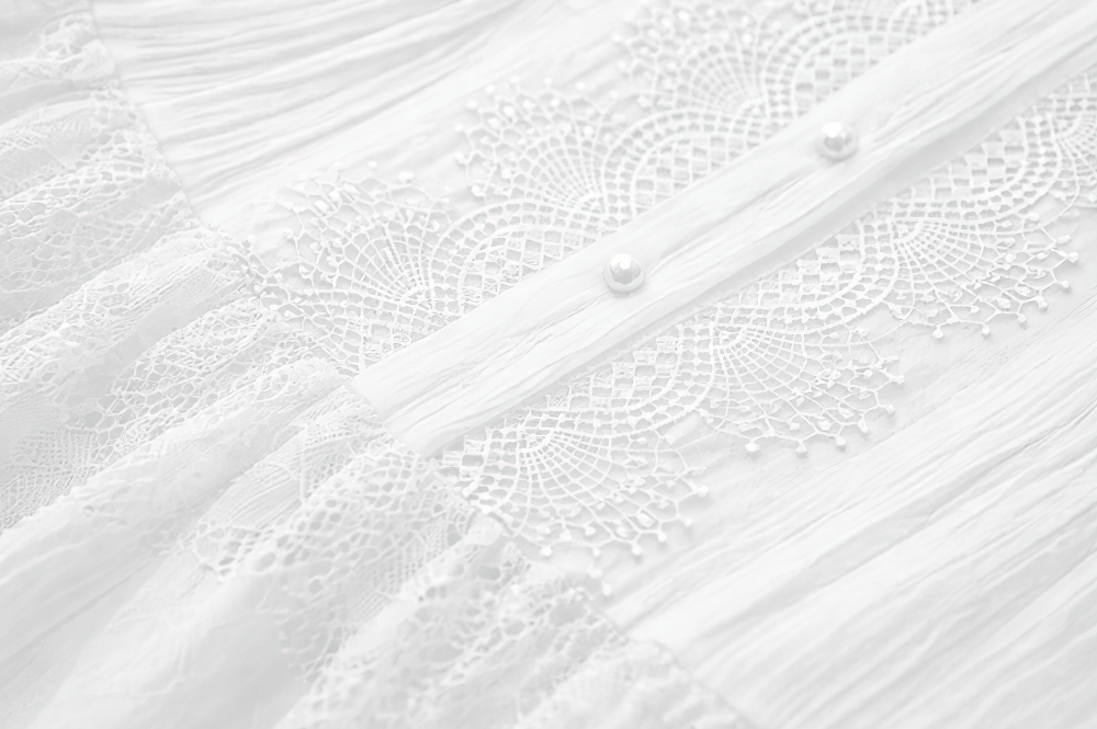 White Gothic Lolita Lace Dress with Ruffle Skirt detail showcasing intricate lace and button design.