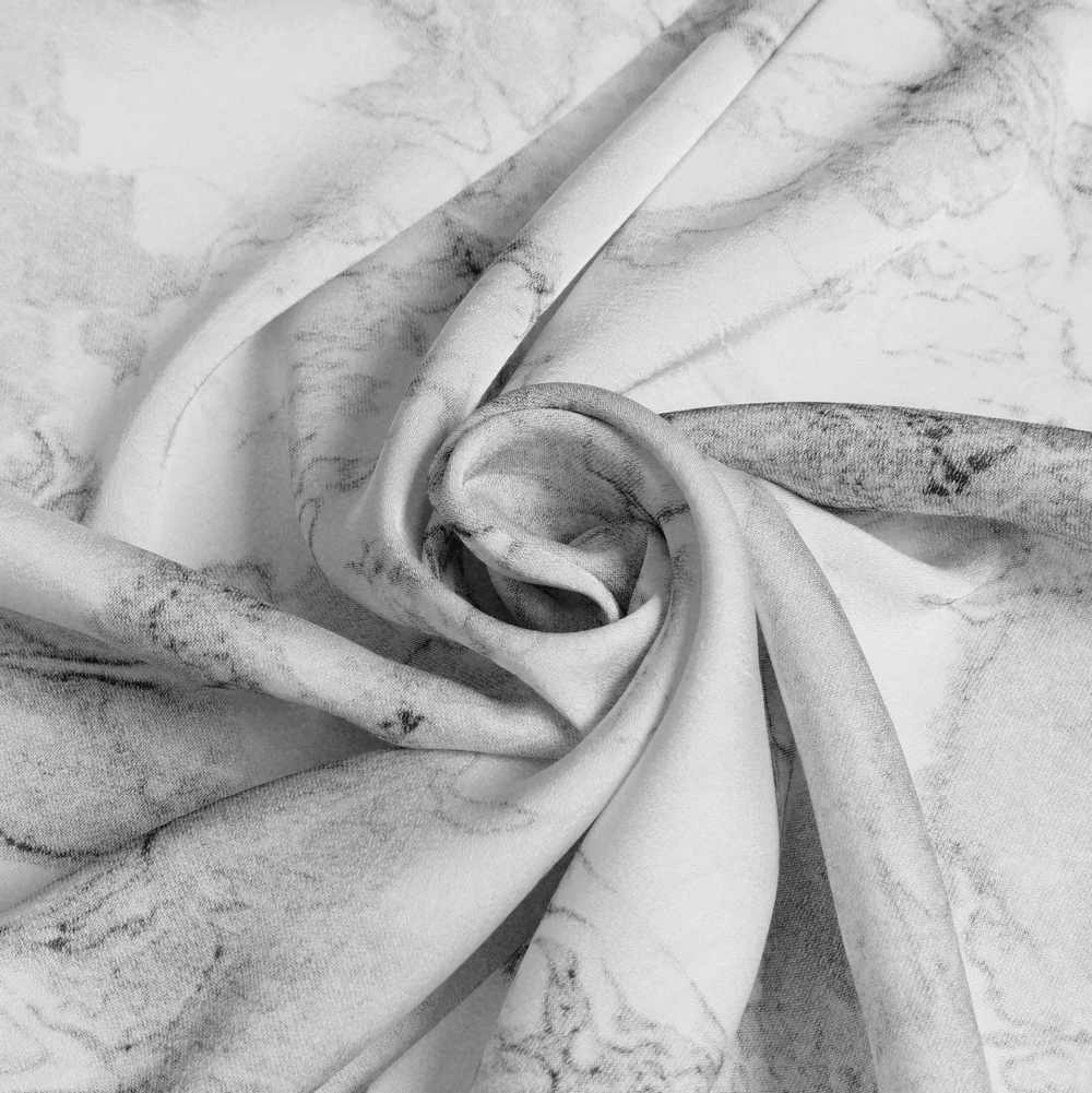 Close-up of fabric featuring a white marble print, perfect for a White Gothic Marble Shirt with Lace Ruffle Bib.