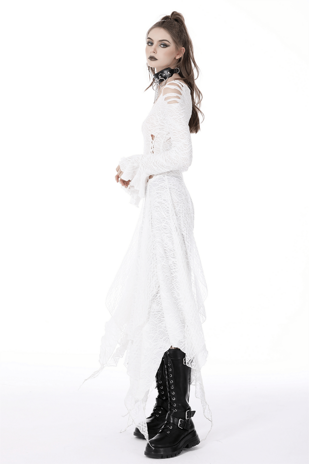 Stylish model in a white Gothic maxi dress with cutouts and trumpet sleeves, paired with combat boots.