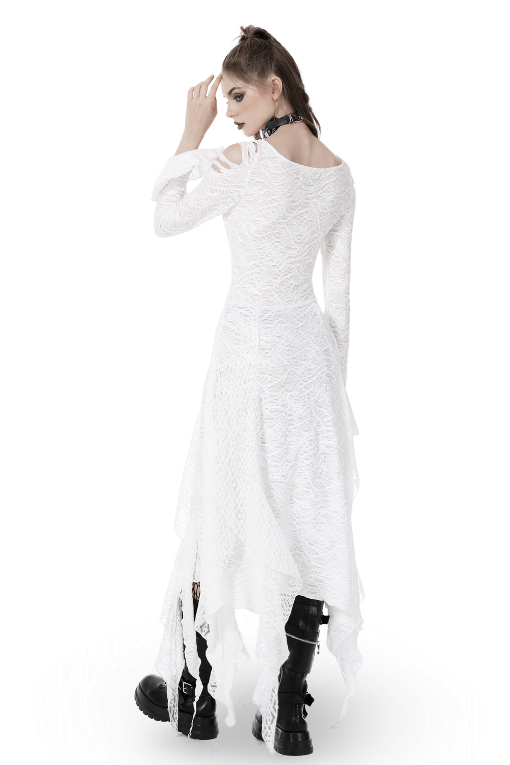Back view of a woman in a white gothic maxi dress with cutouts and trumpet sleeves, paired with black boots.