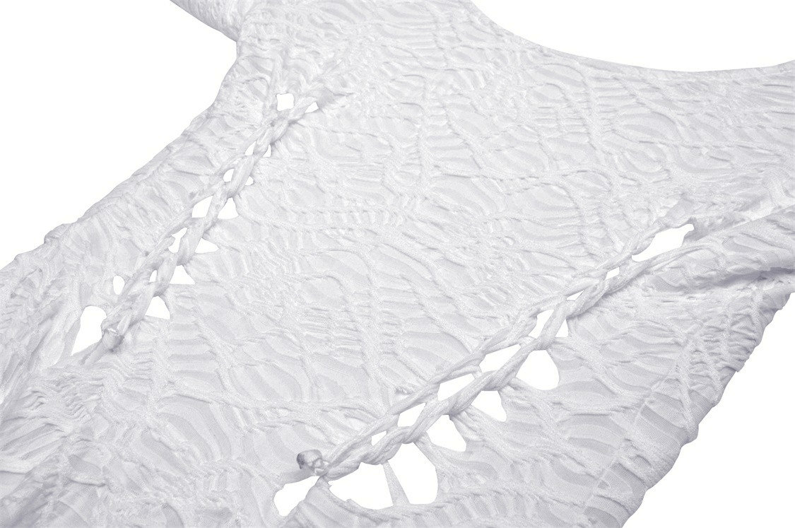 Close-up of white gothic maxi dress showcasing cutout detailing and textured fabric.