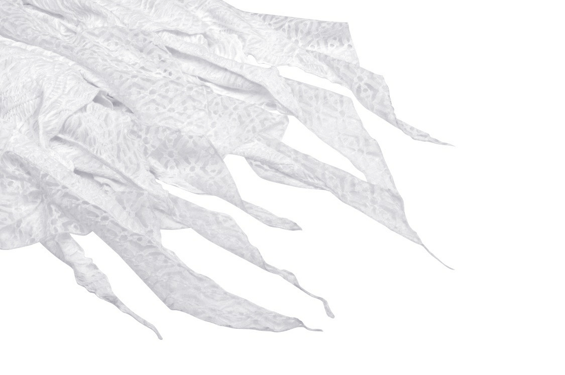White fabric featuring Gothic cutouts, perfect for a unique maxi dress design.