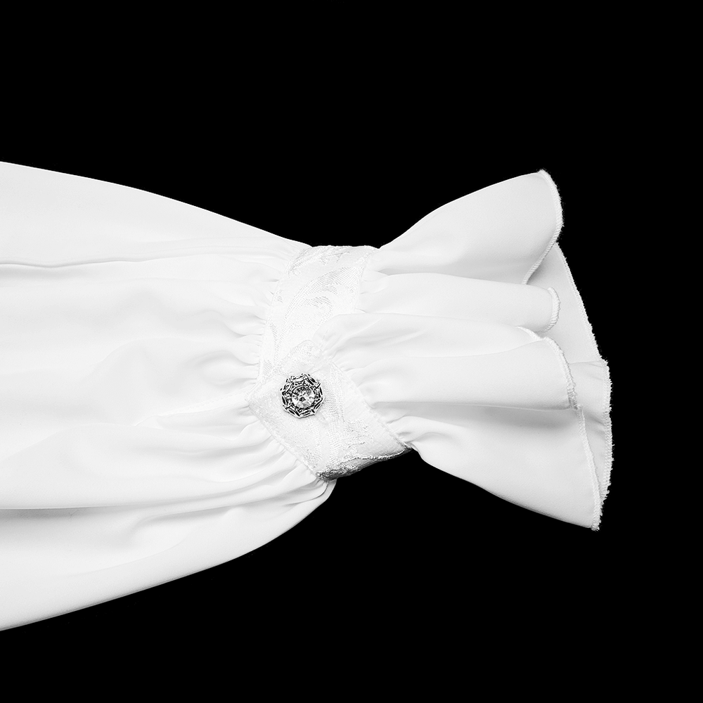 Close-up of a white shirt sleeve featuring lace-trimmed ruffles and an engraved snap button detail.