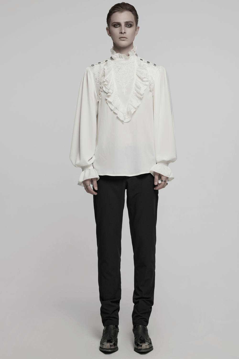 Gothic glamorous white shirt with lace and ruffles, featuring snap buttons, styled with black trousers.