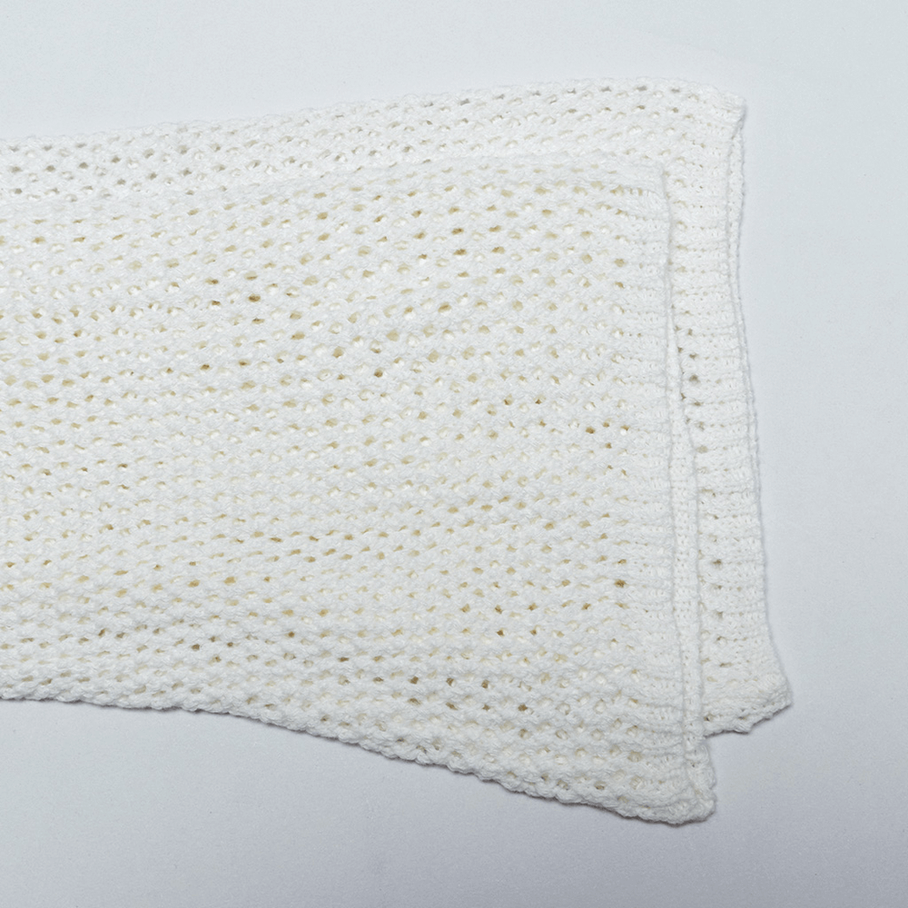 Soft white mesh knit fabric folded elegantly, perfect for crafting unique gothic fashion.