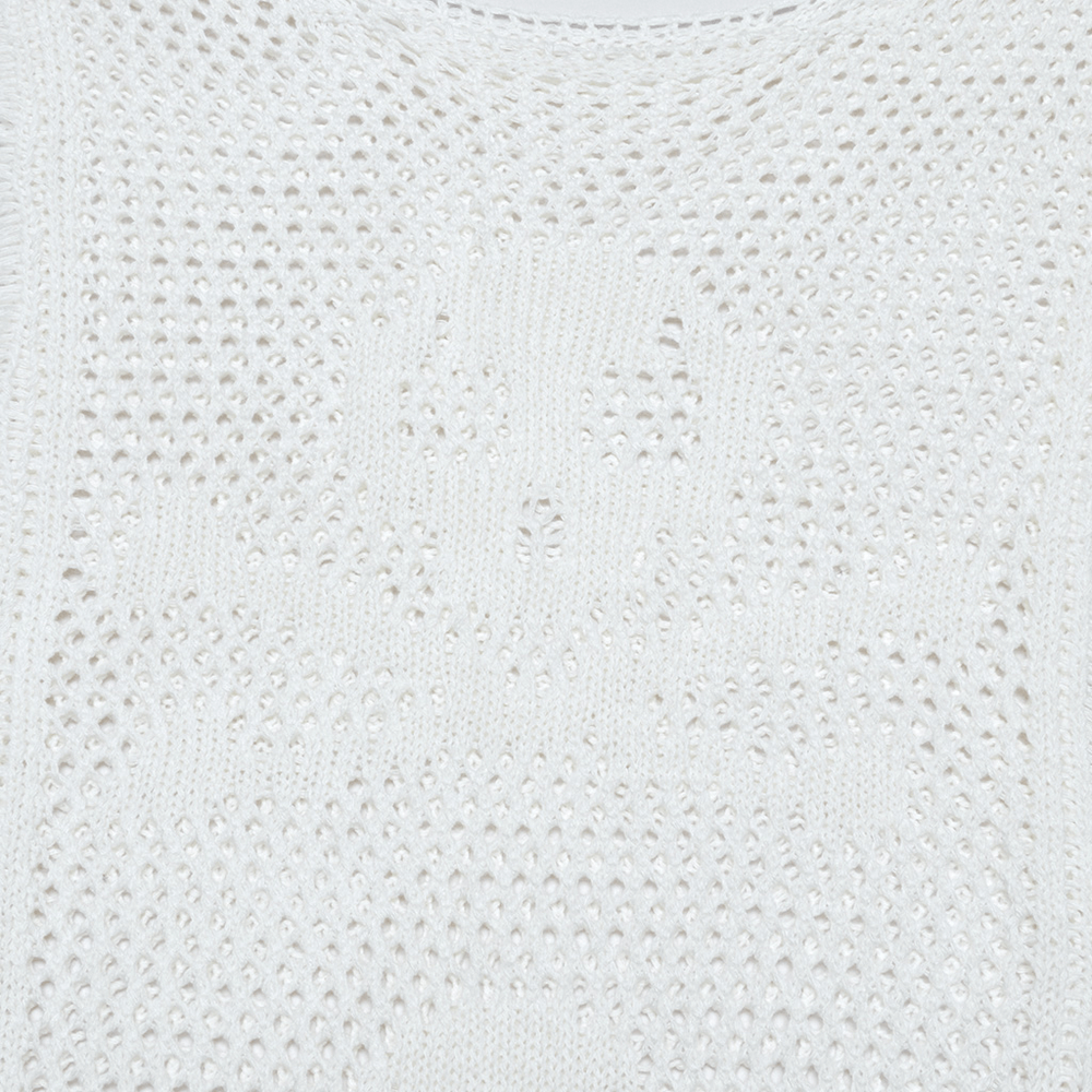 Close-up of white mesh knit dress featuring intricate skull design, highlighting its punk and gothic aesthetic.