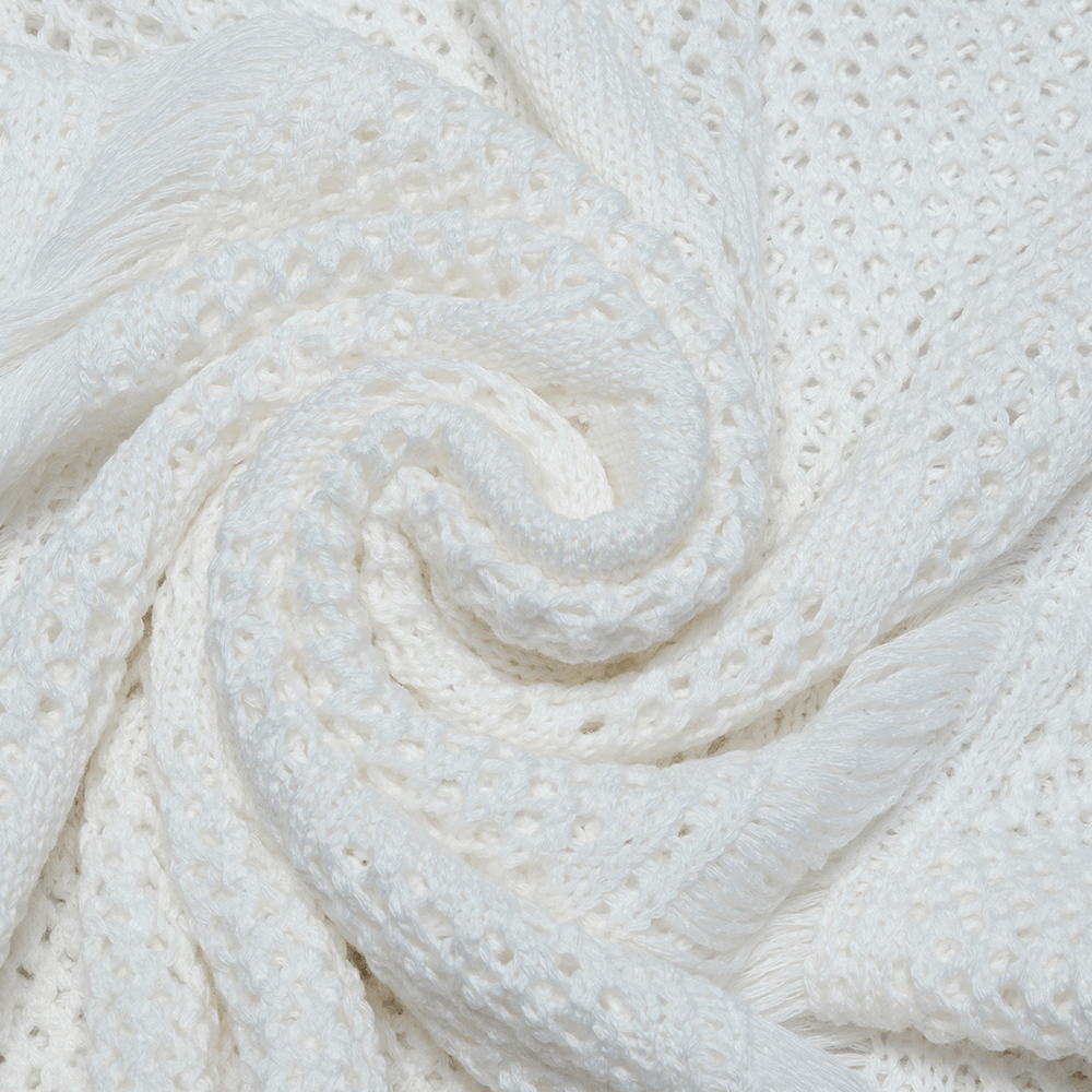 close-up of soft white knitted fabric with intricate patterns and textures, ideal for cozy fashion pieces.