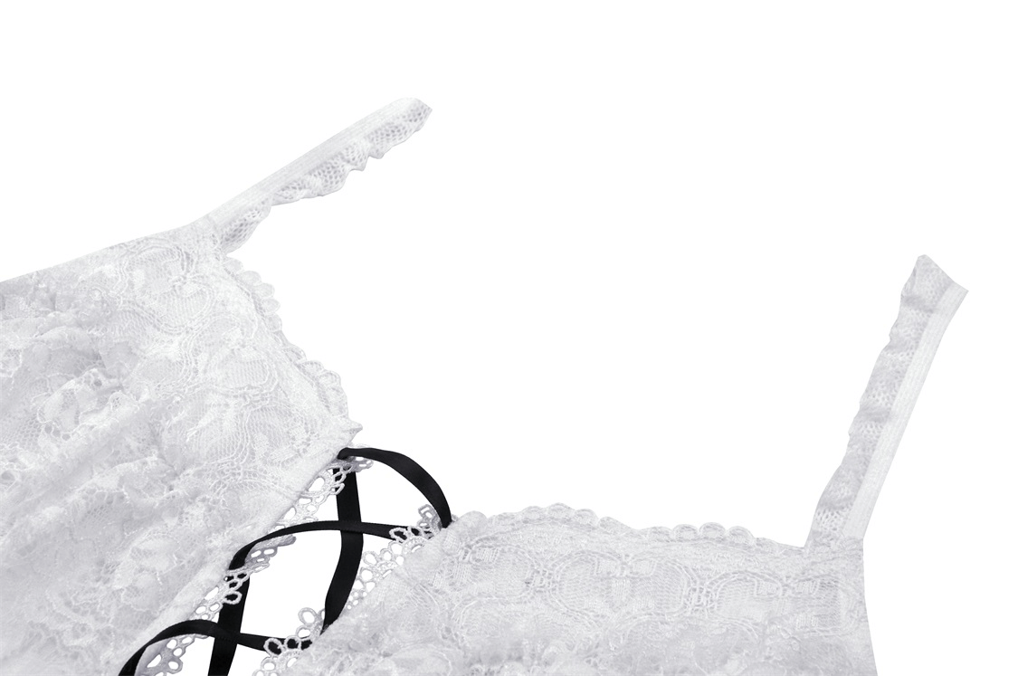 Close-up of a white sleeveless crop top with black lace-up detail and elegant lace accents.