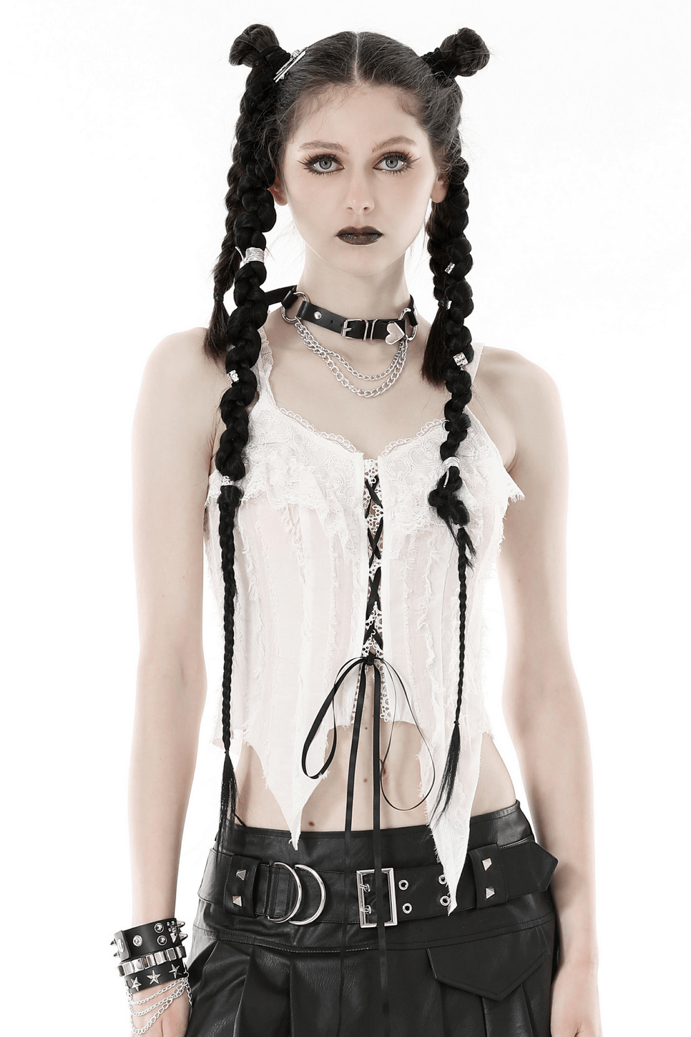 Edgy white sleeveless crop top with black lace-up front, styled with chains and punk accessories.