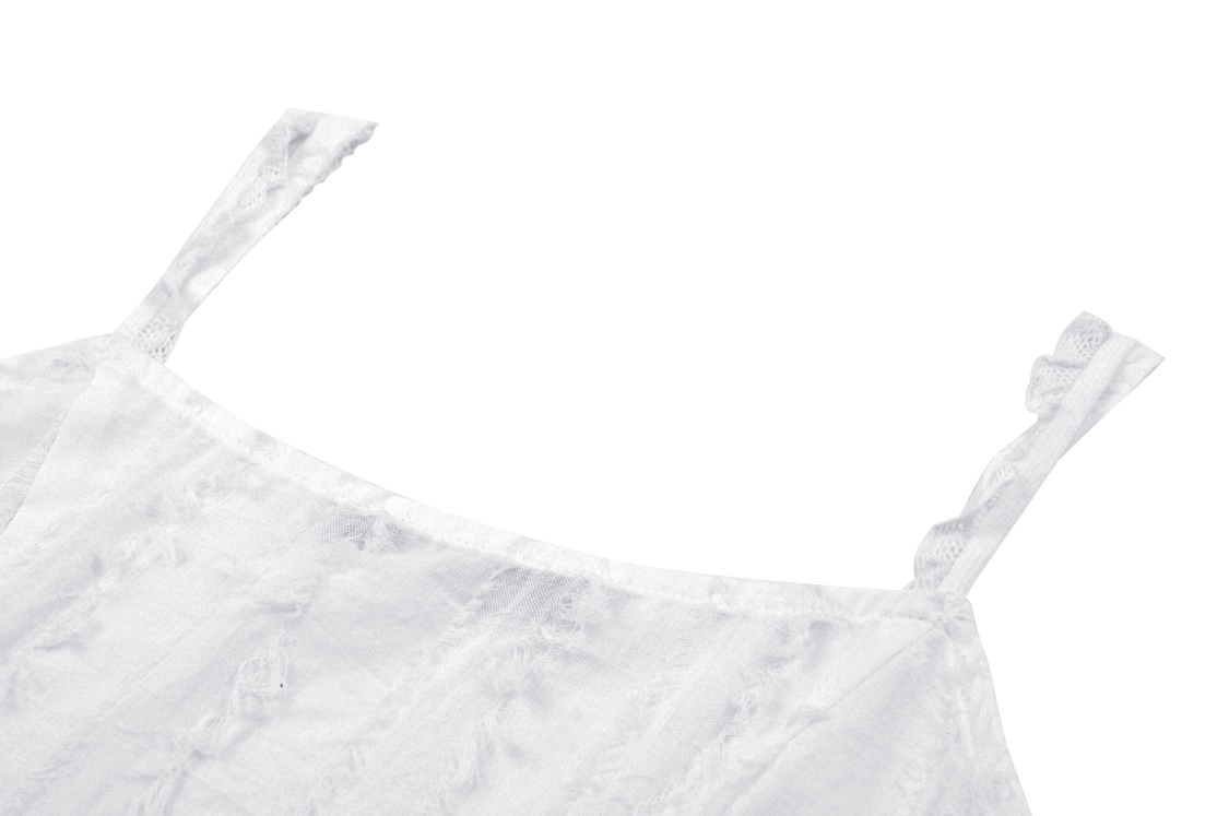 Close-up of a white sleeveless crop top, showcasing delicate straps and textured fabric, perfect for a rockstar vibe.