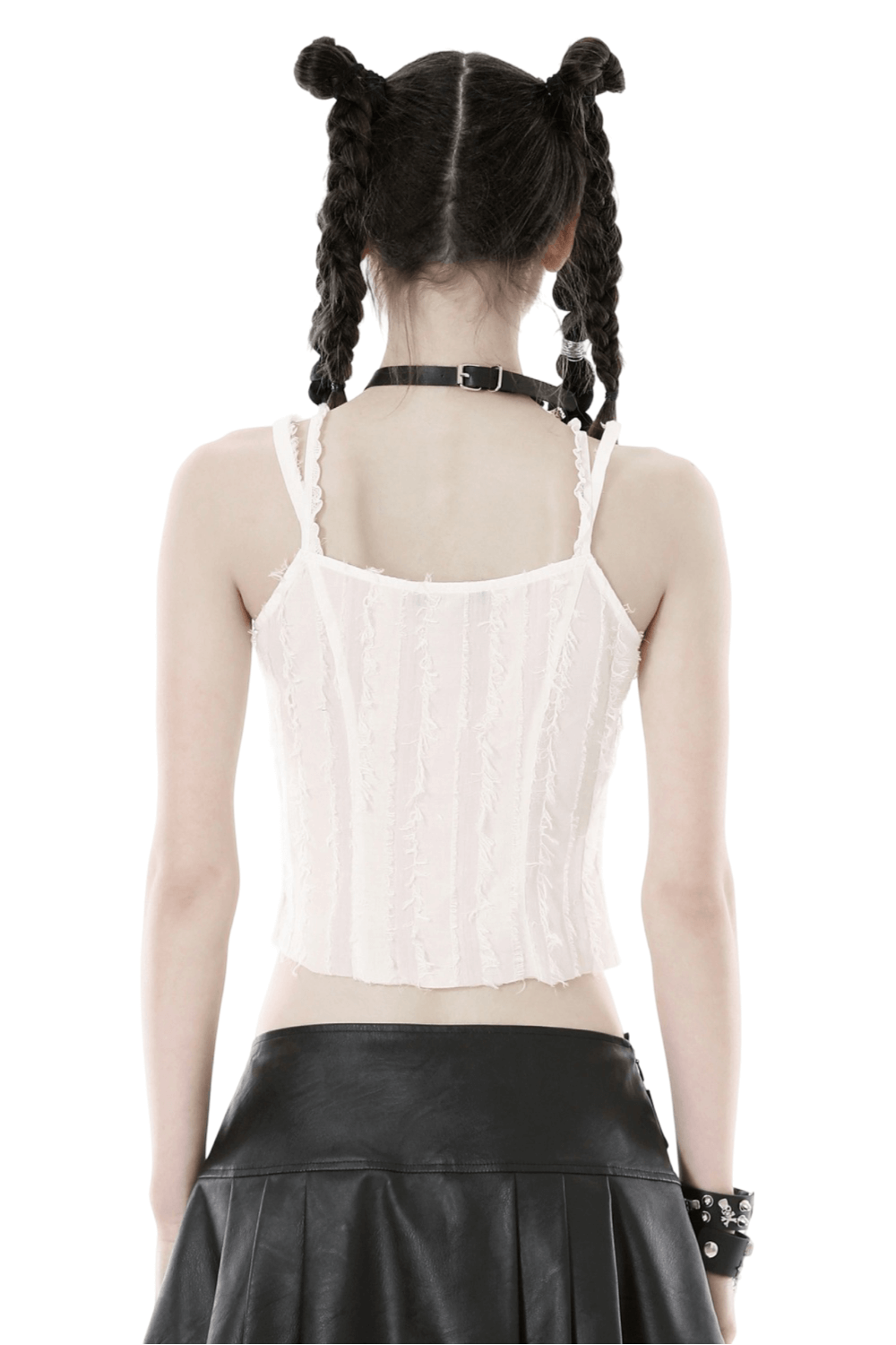 Back view of a girl in a white sleeveless crop top with textured detail, paired with a black leather skirt.