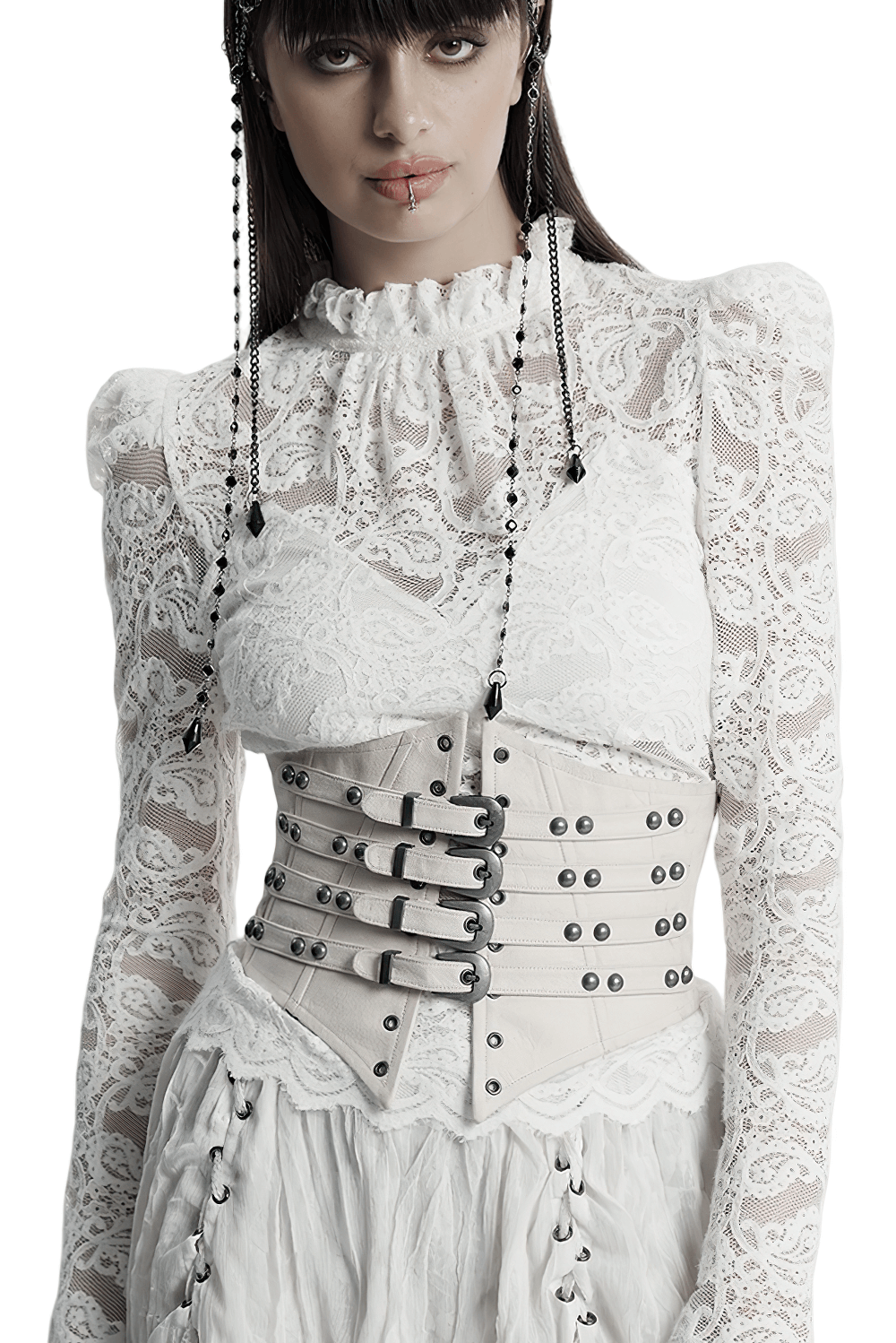 White underbust corset with buckle straps and studded accents, styled with a lace blouse for a punk retro look.