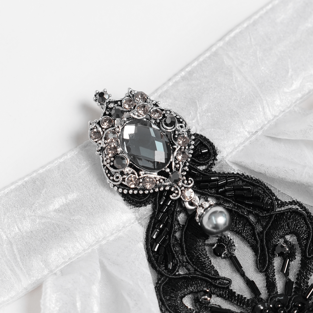 Close-up of brooch detail on the White Victorian Gothic Shirt with Black Lace Jabot Trim, featuring ornate black lace and jewels.