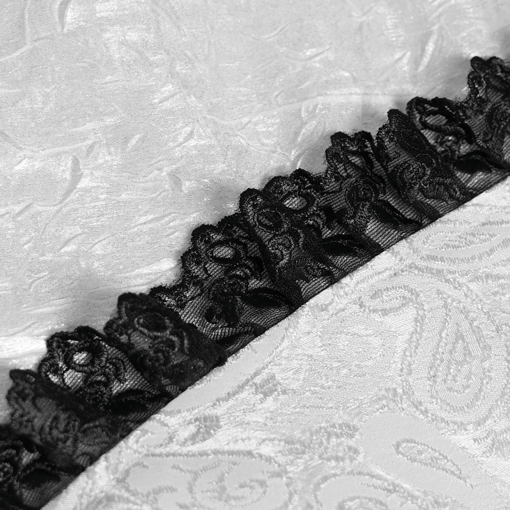 Detail of black lace jabot trim on a white Victorian Gothic Shirt with Black Lace Jabot Trim, showcasing ornate ruffles.