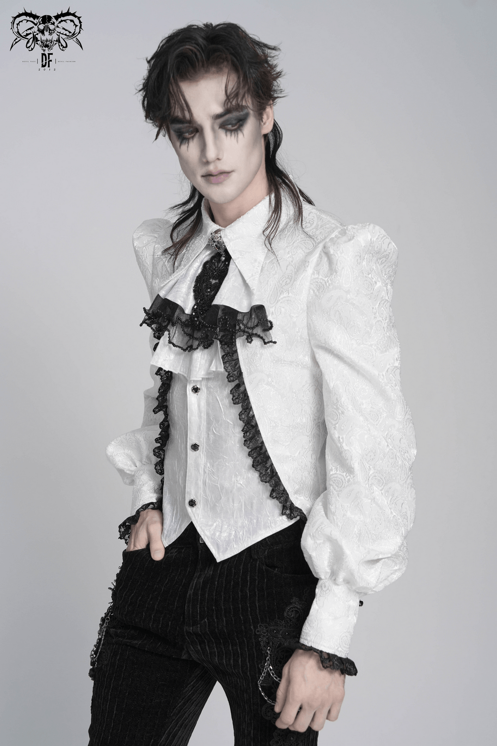 White Victorian Gothic Shirt with Black Lace Jabot Trim displayed by a model with a dramatic look and puff sleeves.