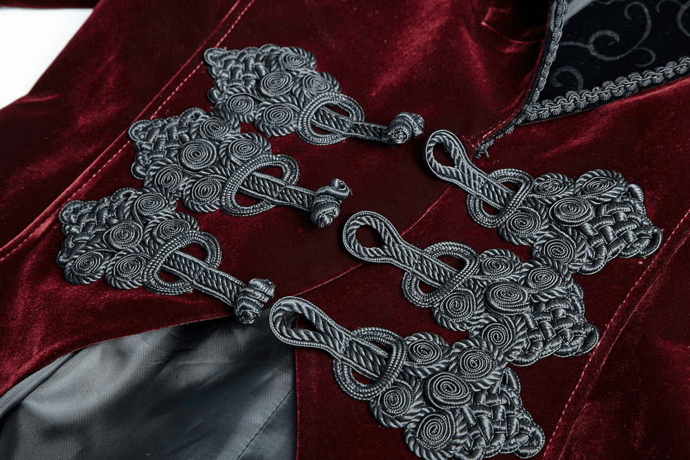 Close-up of elegant wine red gothic jacket detailing with intricate black buttons and scissor tail design.