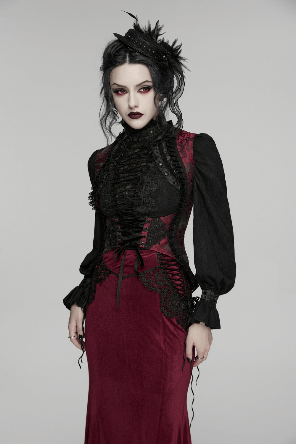 Alt Tag: Wine Red Gothic Lace Trim Corset Vest with Drawstrings on model, lace-up bodice with black sleeves, vampy gothic fashion look
