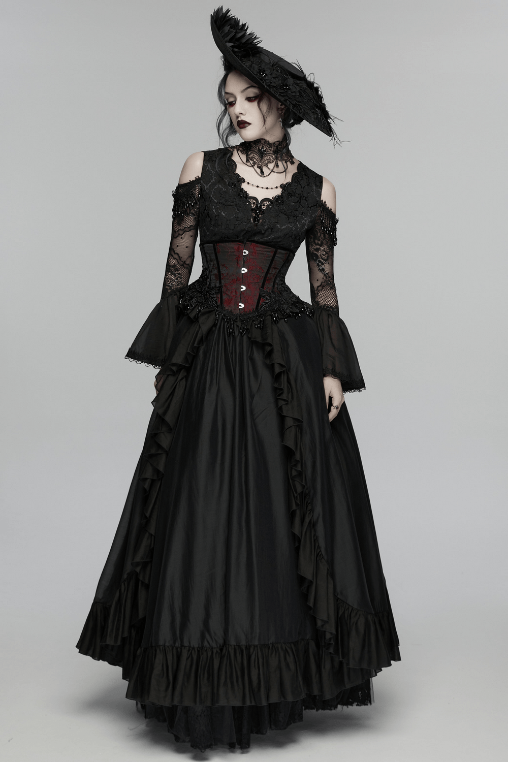 Alt Tag: Wine Red Jacquard Gothic Underbust Corset with Fringe on model with black lace sleeves, beaded tassels, and lace-up back