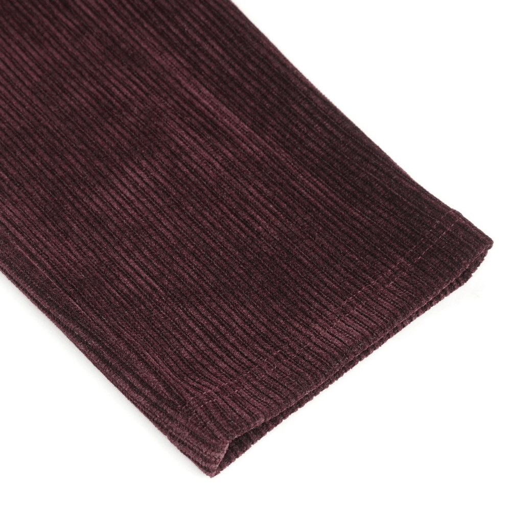 Close-up of wine red lace-trimmed corduroy trouser hem showcasing rich texture and quality craftsmanship.