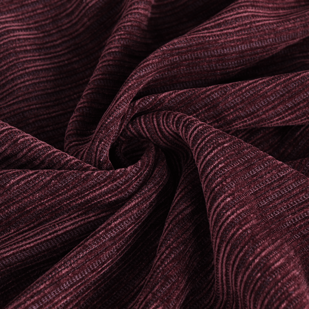 Close-up of wine red corduroy fabric showcasing textured lines and a rich, luxurious feel.