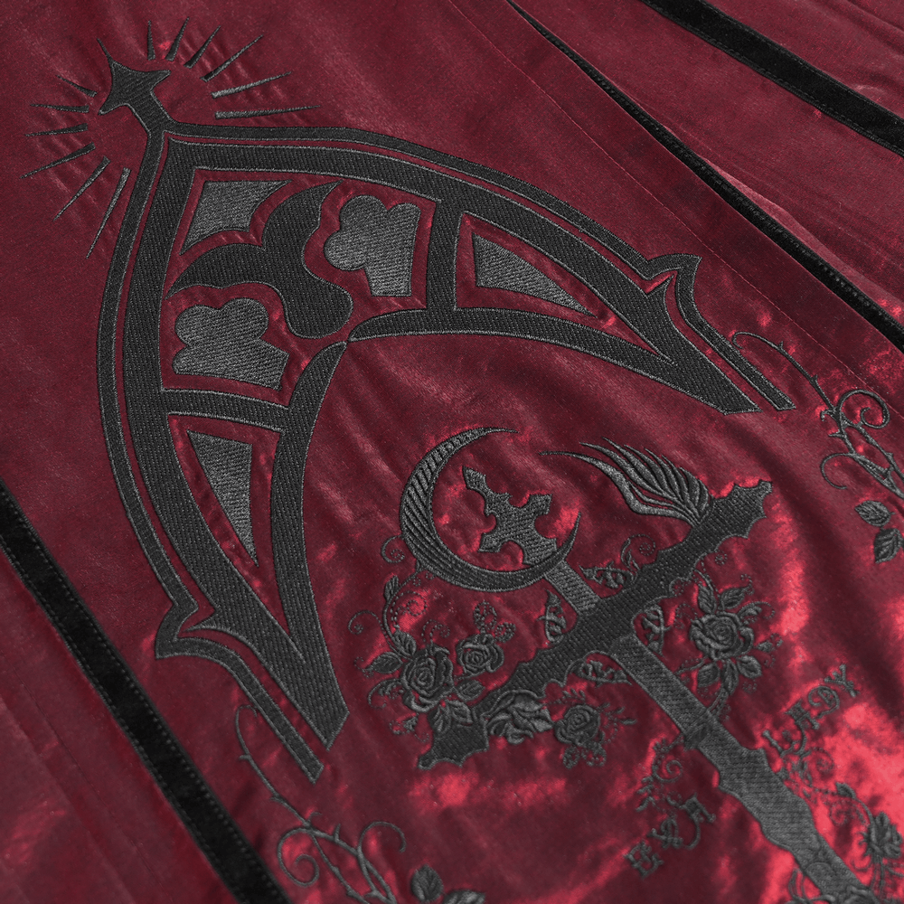 Close-up of gothic wine red maxi skirt featuring ornate black embroidery and intricate lace details.