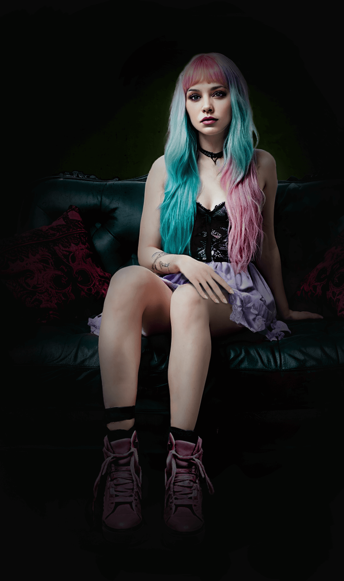 Woman with pink hair sits on couch in a gothic setting