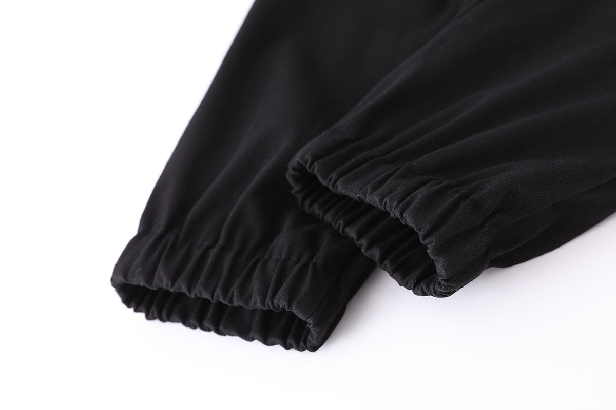 Close-up of black high waist women's joggers featuring elastic cuffs, showcasing a rock style fit.
