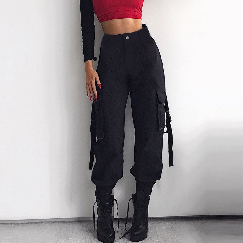 Women’s black high waist cargo joggers with suspenders, perfect for a rock or goth outfit, shown with a cropped top.