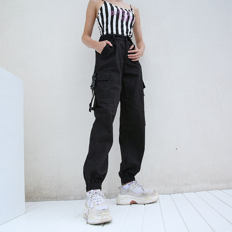Women black high waist cargo joggers with suspenders, styled in rock fashion, perfect for concerts and themed parties.