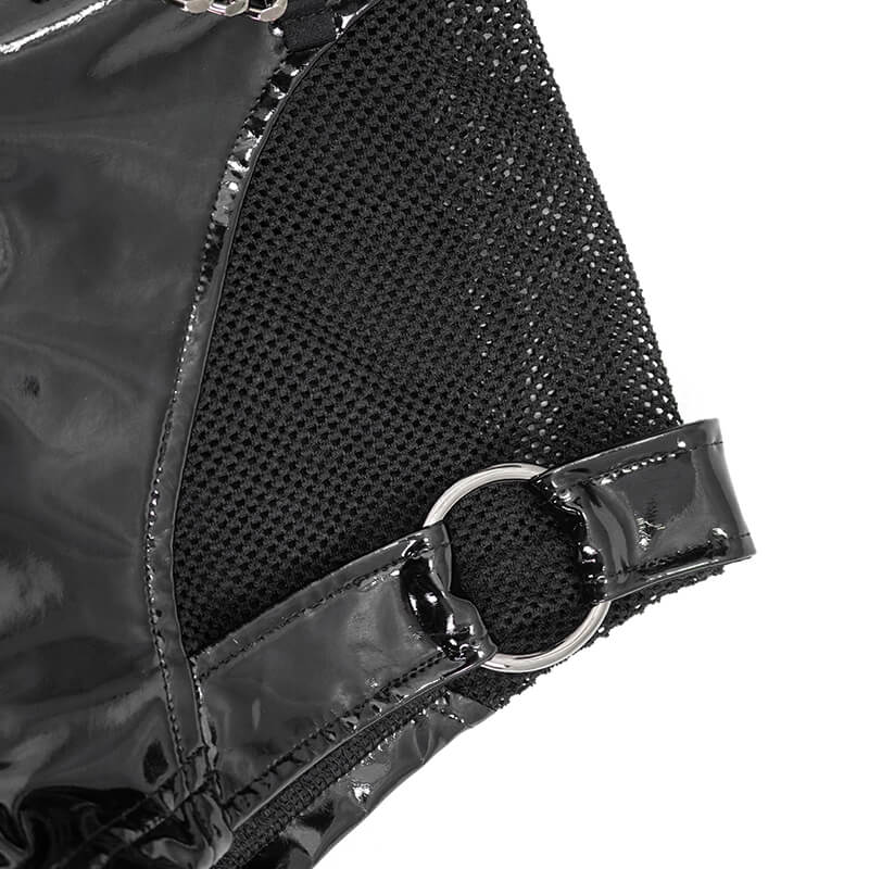 Close-up of women's gothic style black synthetic leather shorts with mesh panel and silver ring accent.