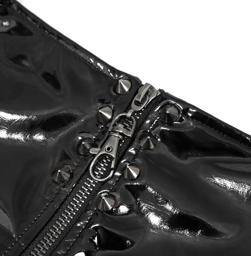 Close-up of gothic black synthetic leather shorts featuring a zipper and silver studs for edgy style.