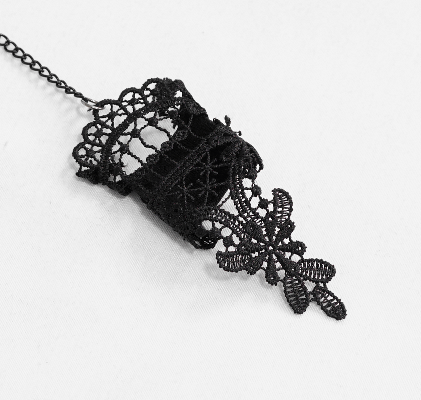 Elegant black lace glove accessory featuring intricate Victorian design and chain detail.