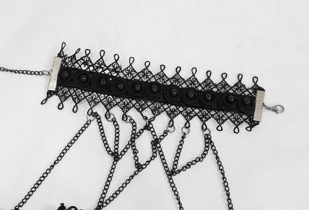 Elegant black lace cuff with chain details, perfect Gothic Victorian accessory for a stylish touch.