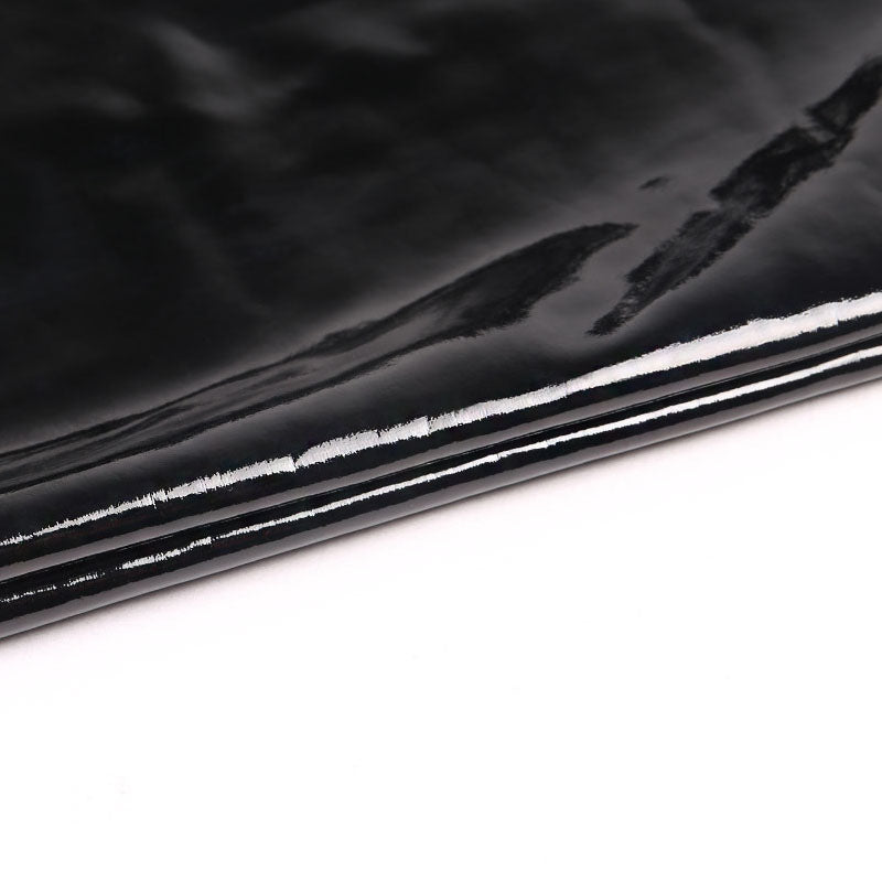 Close-up of shiny black PU leather fabric, perfect for stylish women's leggings with zippers.