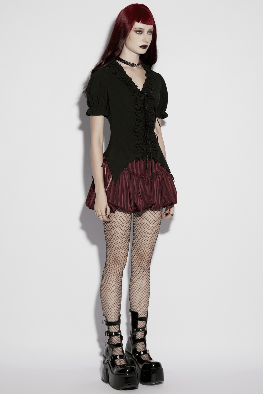 Alt Tag: Women's Adorable Gothic Victorian Blouse with Tie-Up on model, black ruffled top with burgundy skirt and platform boots