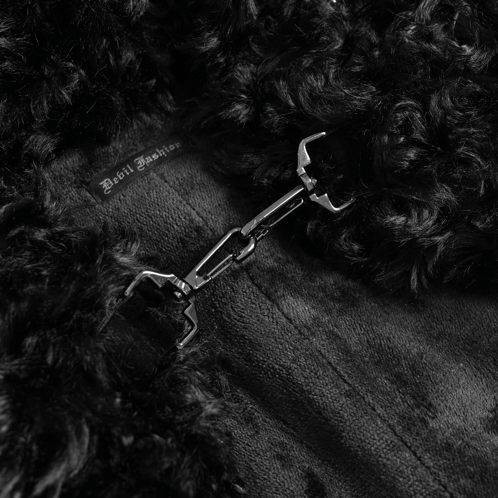 Close-up of black faux fur with silver chain detail from a women's hooded cape for gothic fashion.