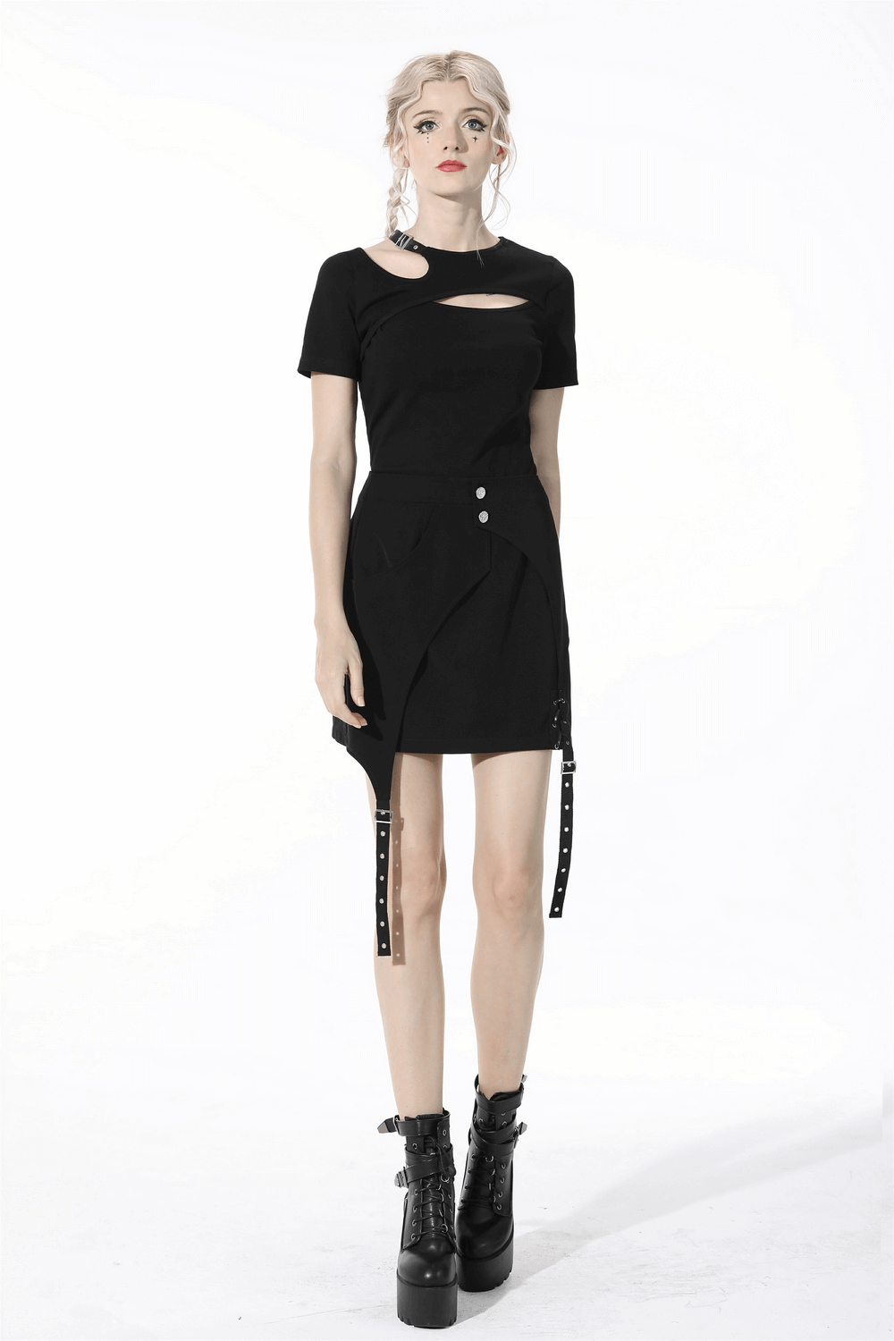 Stylish woman in a black asymmetrical mini skirt with buttons and straps, paired with bold combat boots.