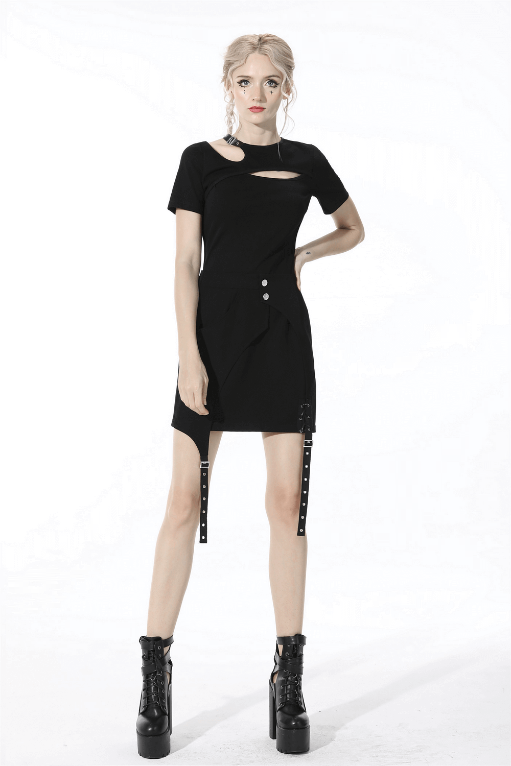 Model showcasing a black asymmetrical mini skirt with buttons and straps, perfect for a punk rock style.