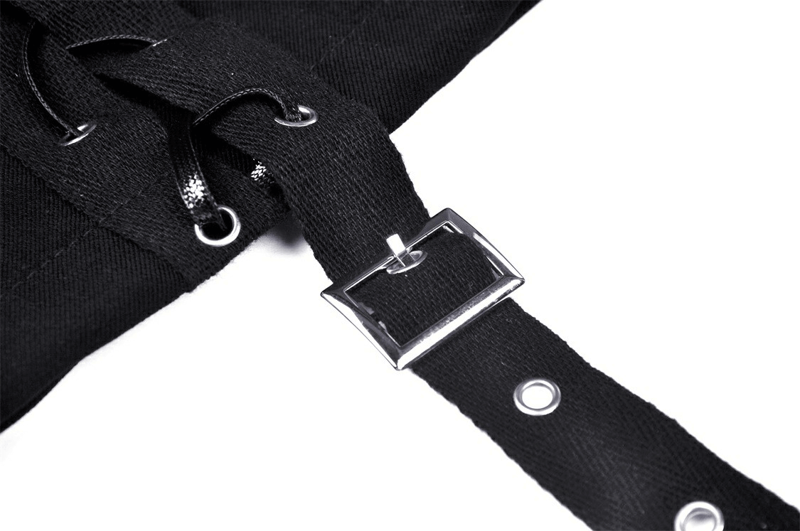 Close-up of black strap and buckle detail on an asymmetrical mini skirt, adding a punk rock touch.