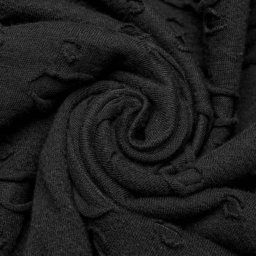 Close-up of black decayed mesh fabric with a spiral pattern, showcasing edgy punk style.