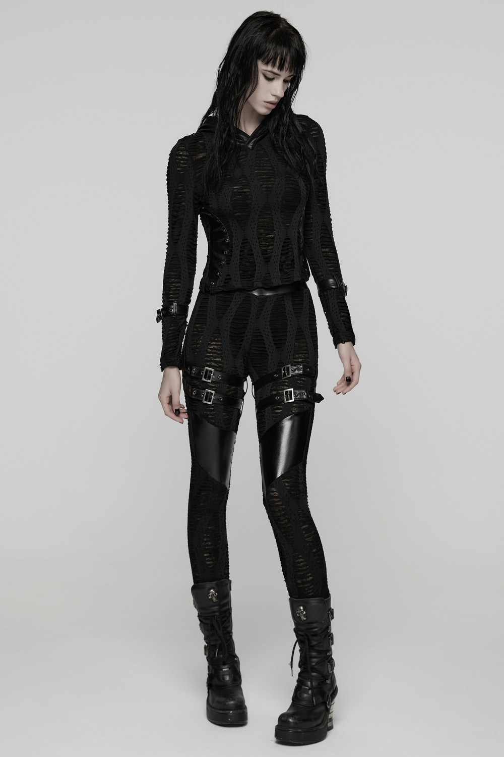 Women's Black Buckled Leggings with Textured Design worn by a model in a stylish pose against a minimalistic backdrop.