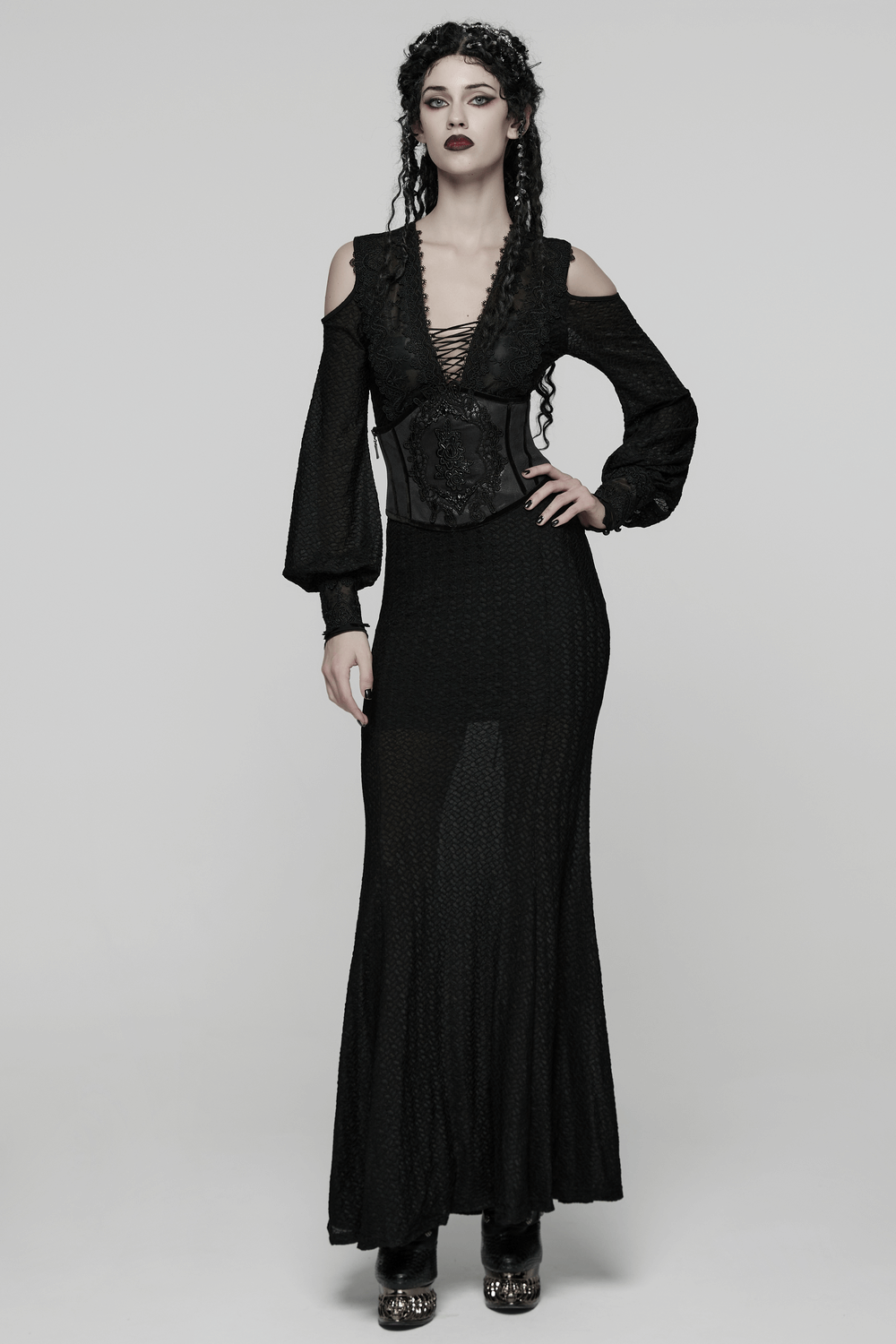 Women's Black Corset Belt with Embroidered Appliques paired with a gothic black dress for a striking look.