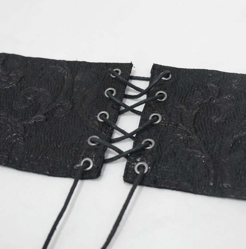 Close-up of a black lace-up girdle with intricate texture and wide lacings for gothic style outfits.