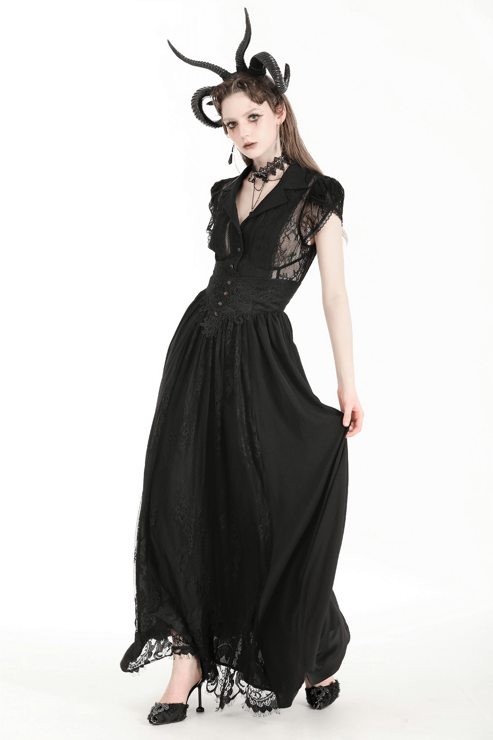 Model wearing a gothic black lace blouse with puff sleeves, embodying elegance and mystery.