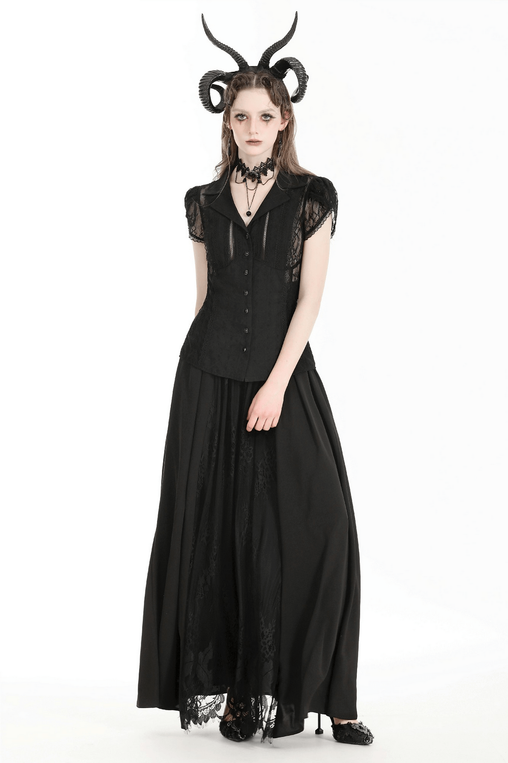 Gothic woman in a black lace blouse and long skirt, featuring puff sleeves and dramatic accessories for an elegant look.